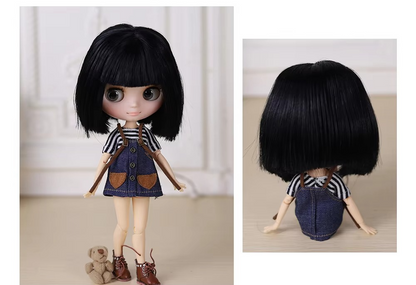Middie Blythe Doll with short black hair and matte face, wearing a striped shirt and denim dress, holding a teddy bear.
