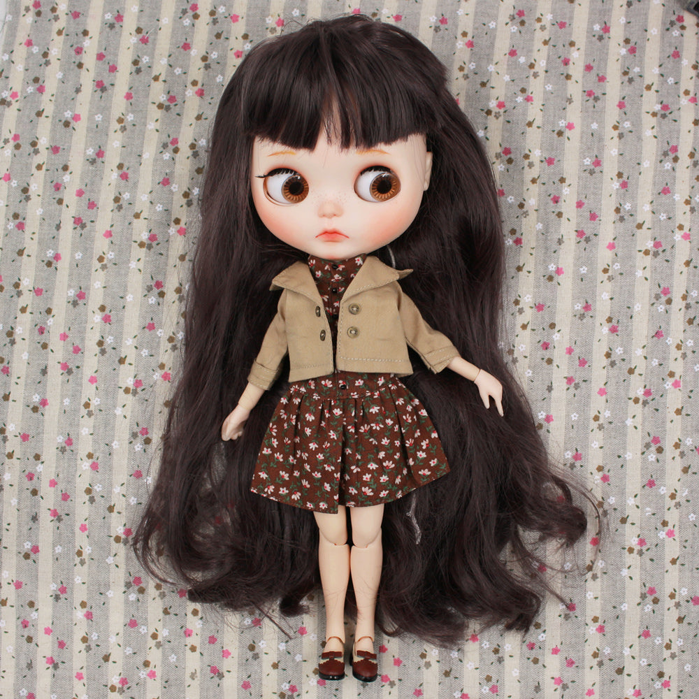 Neo Blythe doll wearing a brown jacket and floral dress on a patterned background. Perfect for BJD collectors.