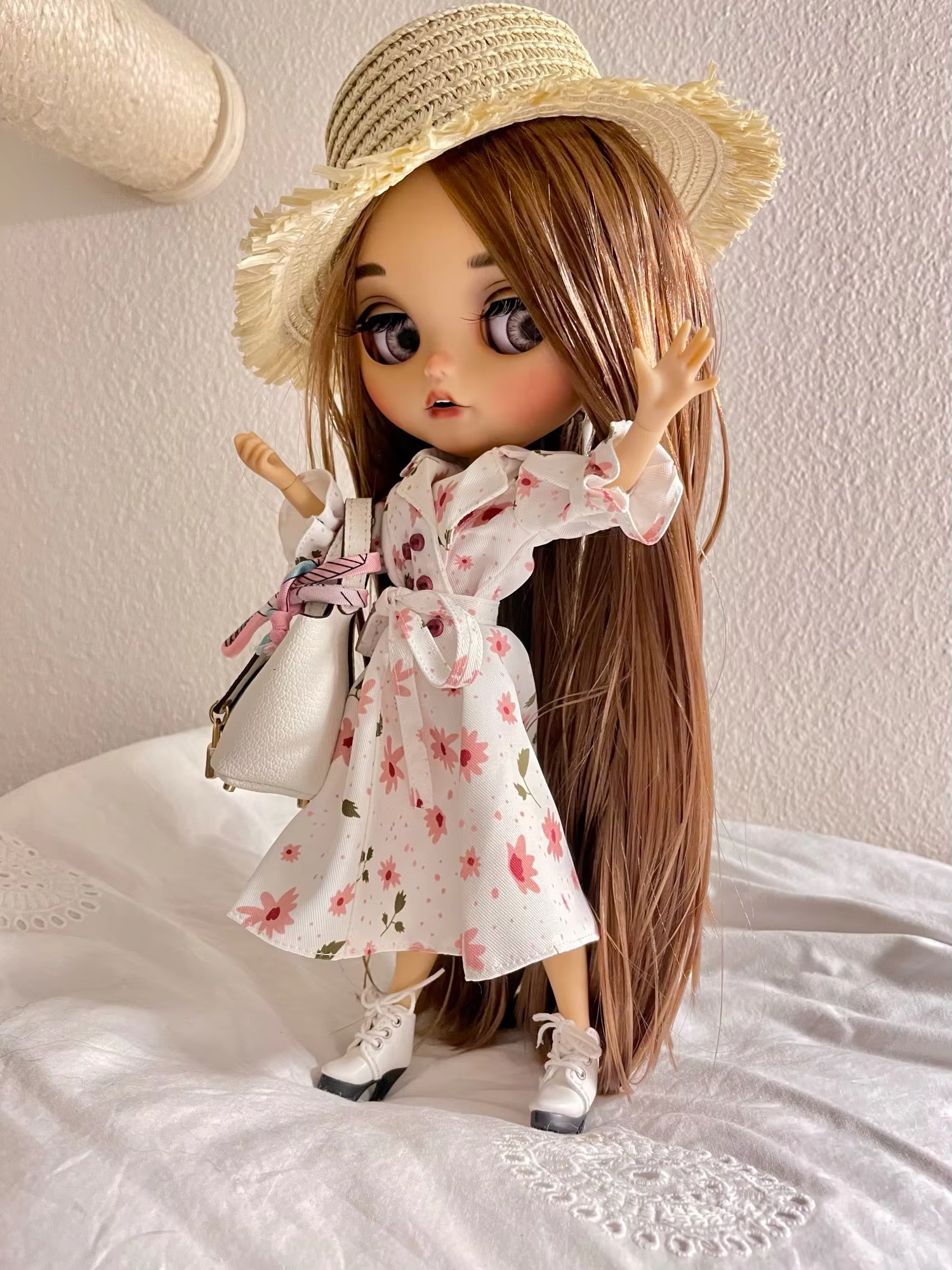 Neo Blythe doll wearing a white floral dress and straw hat, holding a handbag, posing on a white blanket.