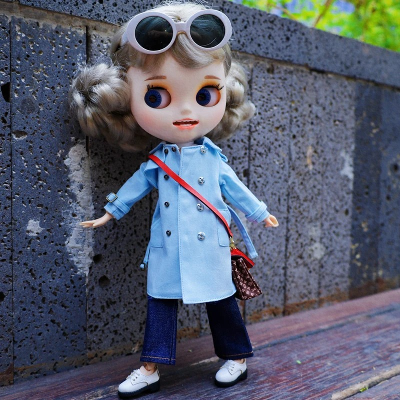 Neo Blythe doll wearing a stylish blue trench coat with sunglasses and denim, showcasing trendy outfit details.